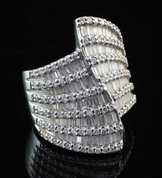 A stylish modern 18ct white gold and baguette and brilliant cut diamond dress ring, size P.